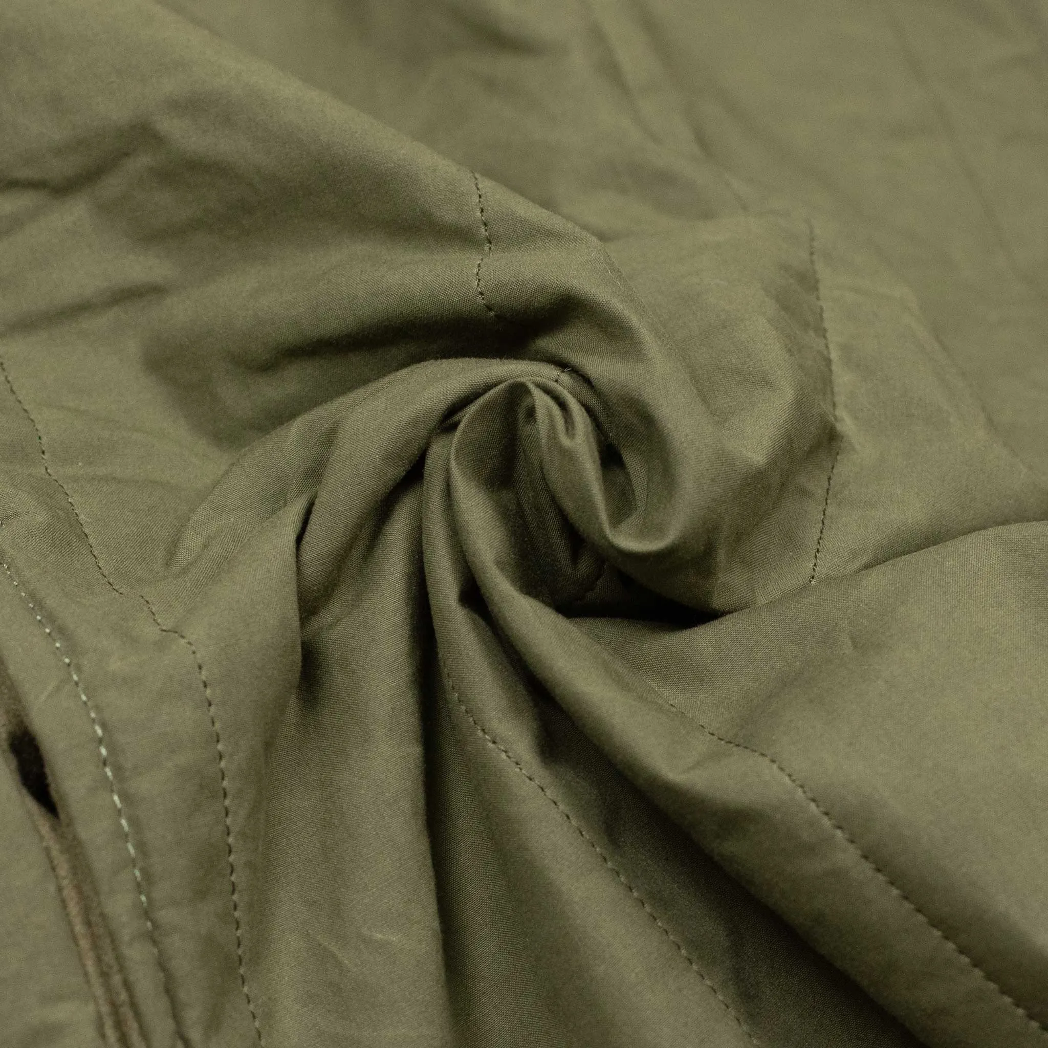 Reversible wadded gilet in fern green moleskin and dry wax cotton