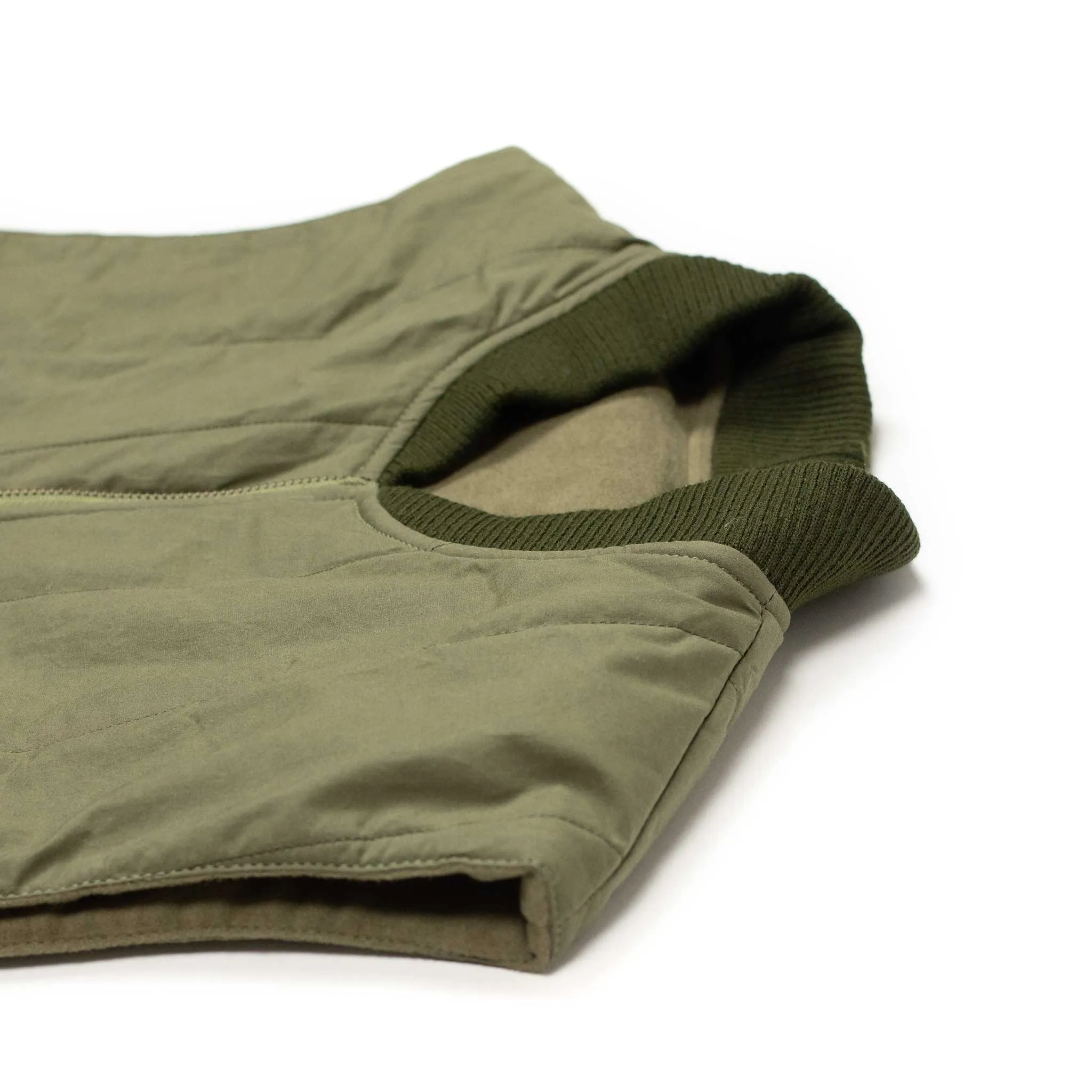 Reversible wadded gilet in fern green moleskin and dry wax cotton