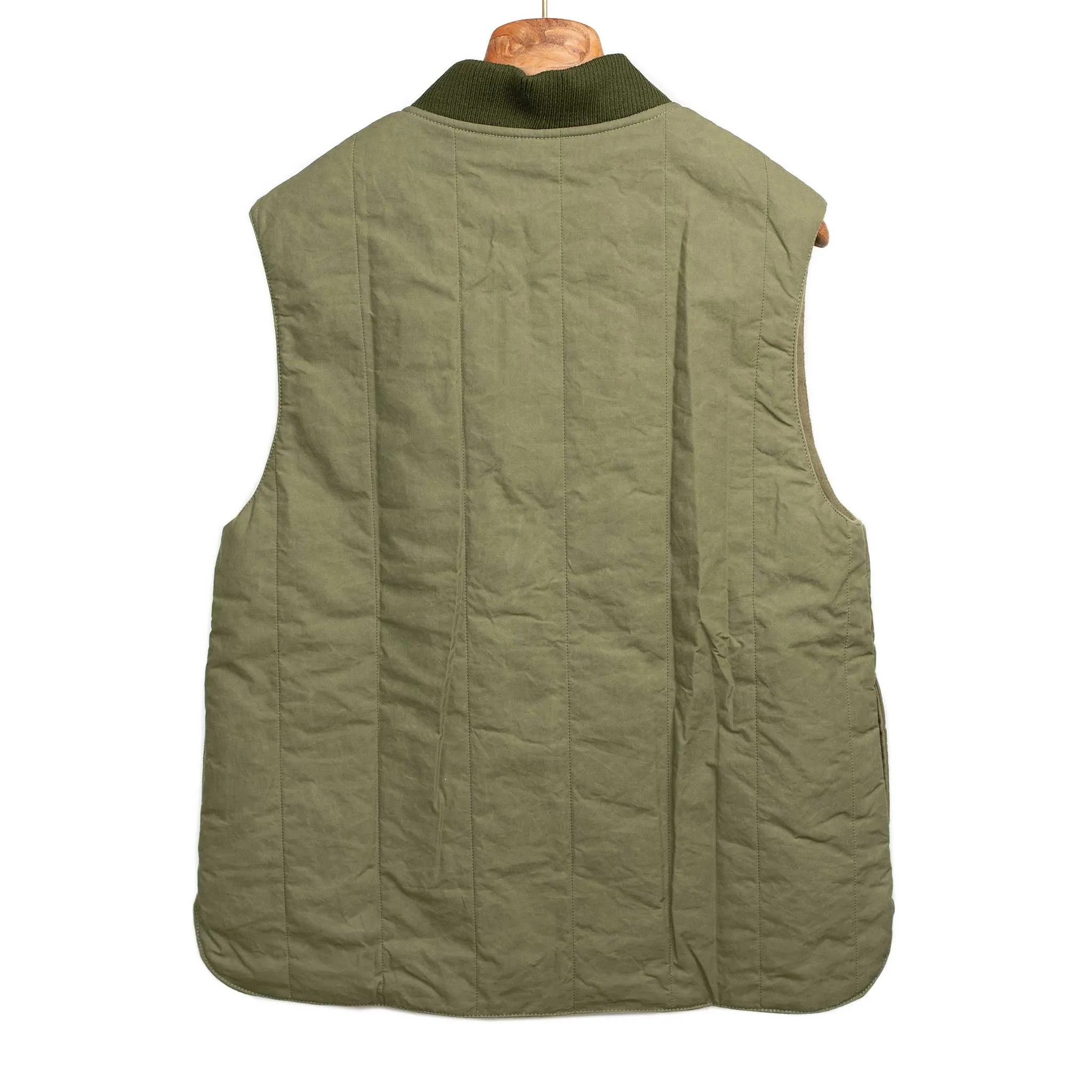 Reversible wadded gilet in fern green moleskin and dry wax cotton